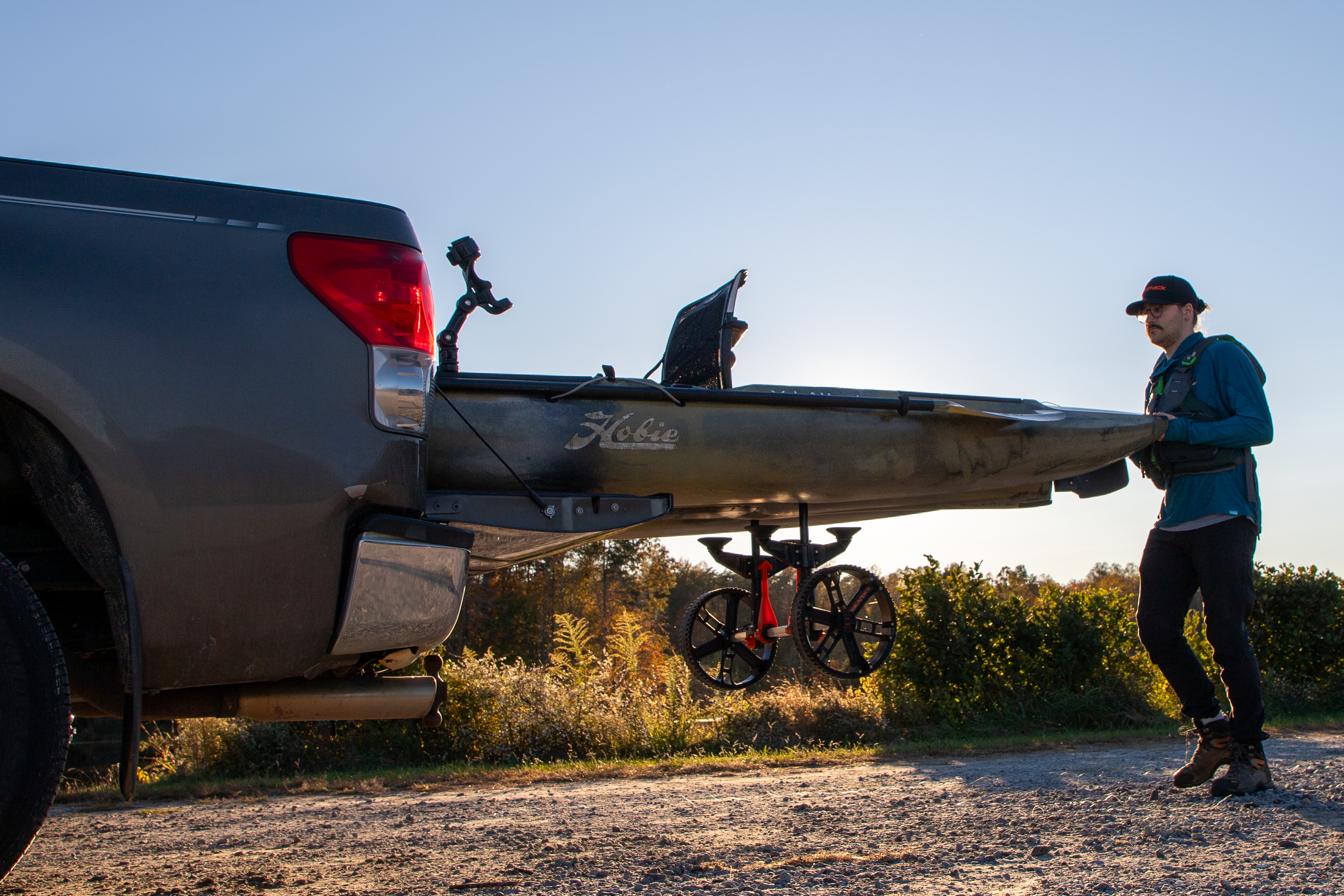 transporting a hobie kayak in a truck bed using a yakattack scupper kayak cart