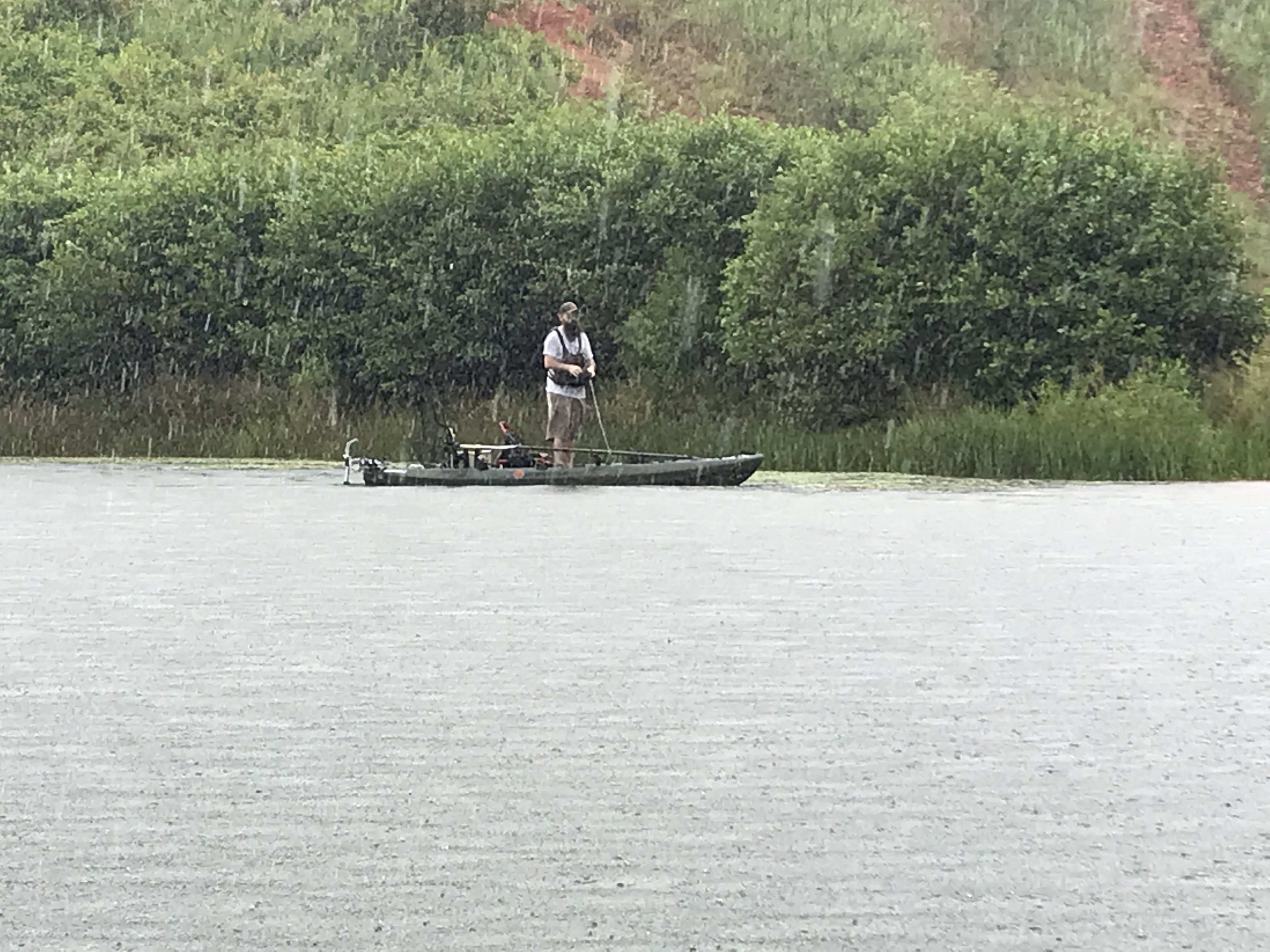 Scott Beutjer fishing in the rain from his Crescent Kayak