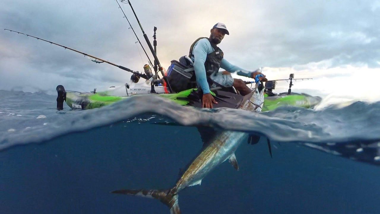 Kwanza Henderson with a sail fish from his Oldtown Kayak