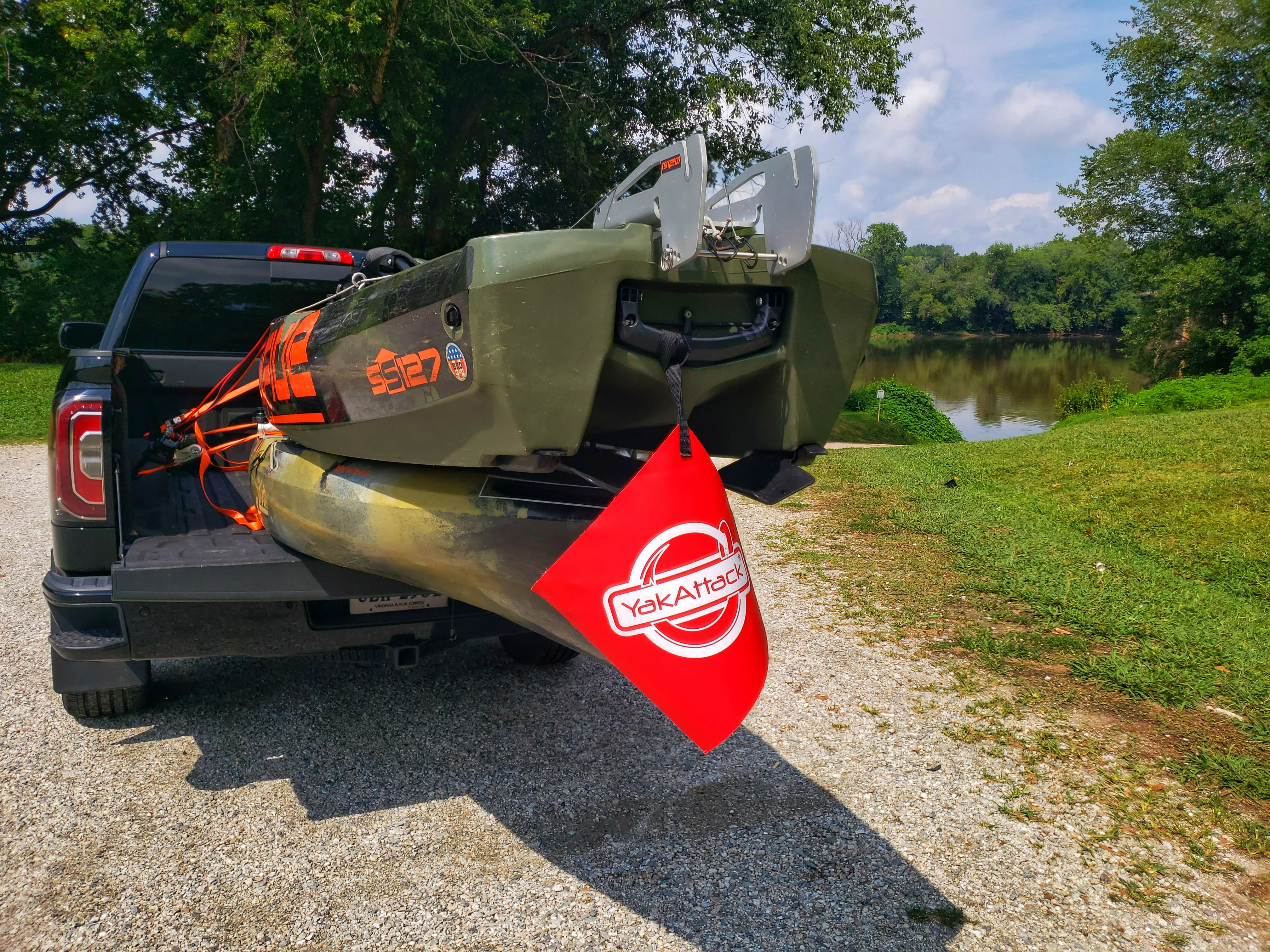 In most states a high visibility tow flag is required when transporting kayaks in the back of truck bed.